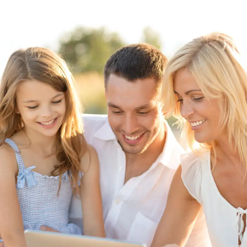 A family of three smiling together.