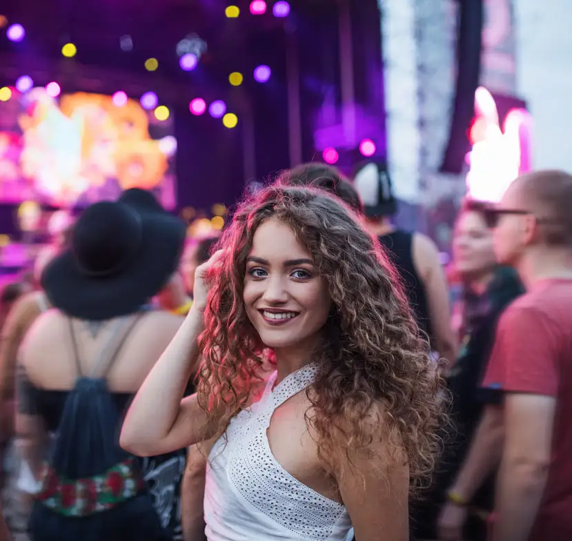 Woman looking back at a concert. 